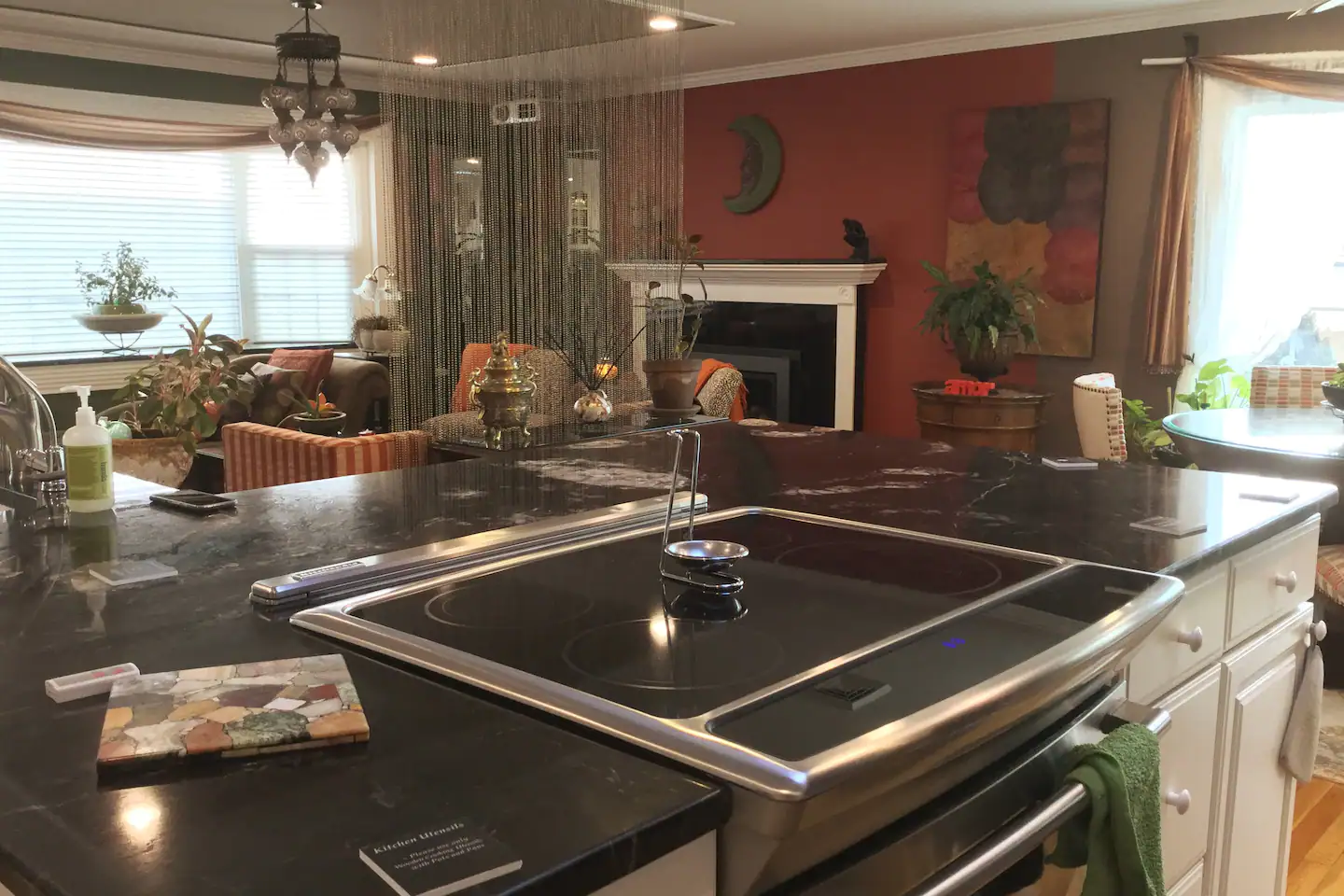 Cooking is a breeze in the kitchen area with many extras: island, two sinks, reverse-osmosis water filter, plentiful cabinet space, induction cooktop with double ovens, sitting area for two on island – all under skylight and Turkish lights.