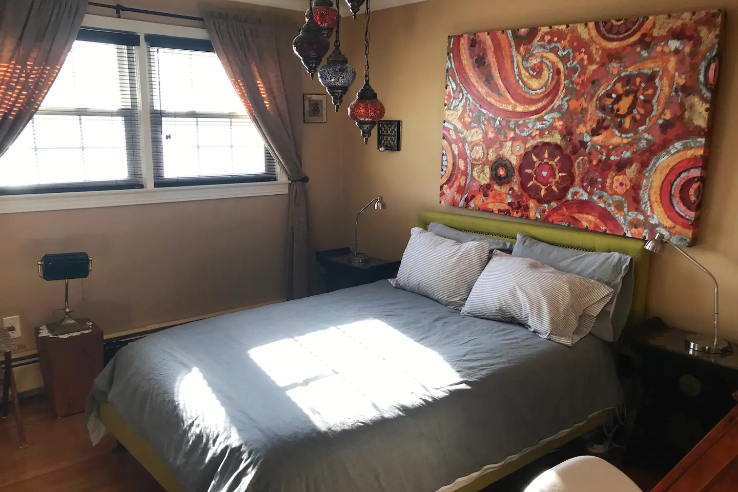 Full Bed/Office: 'Spring' Bedroom In the Spring bedroom, discover a full-size bed, unique fabric ceiling, and delightful wall art and art objects.