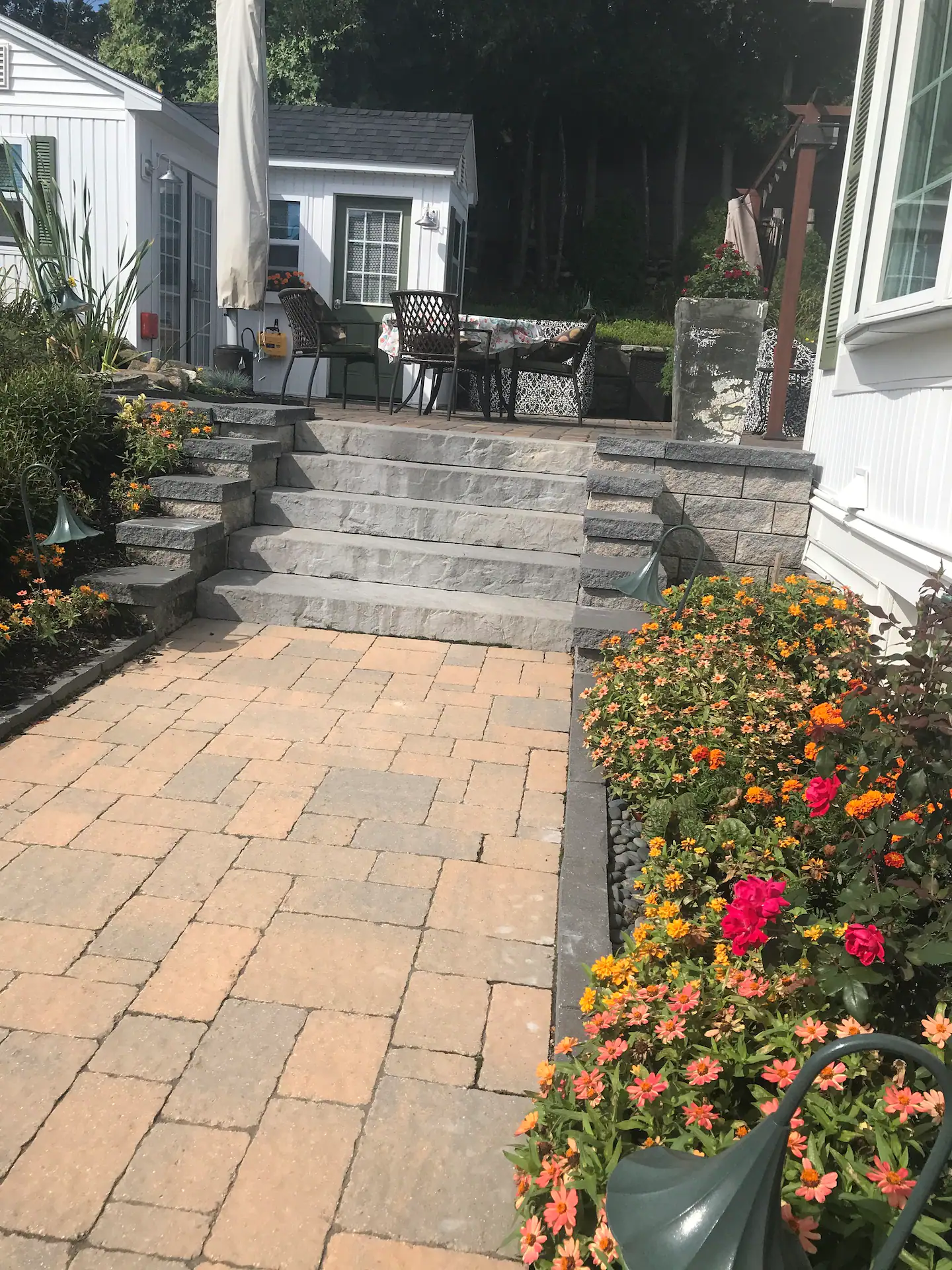 Enter the backyard through your private side gate and head to the pergola straight ahead and to right. Or check out the outside dining area with shade from large, cantilevered umbrella or the rock pond stream to the left.