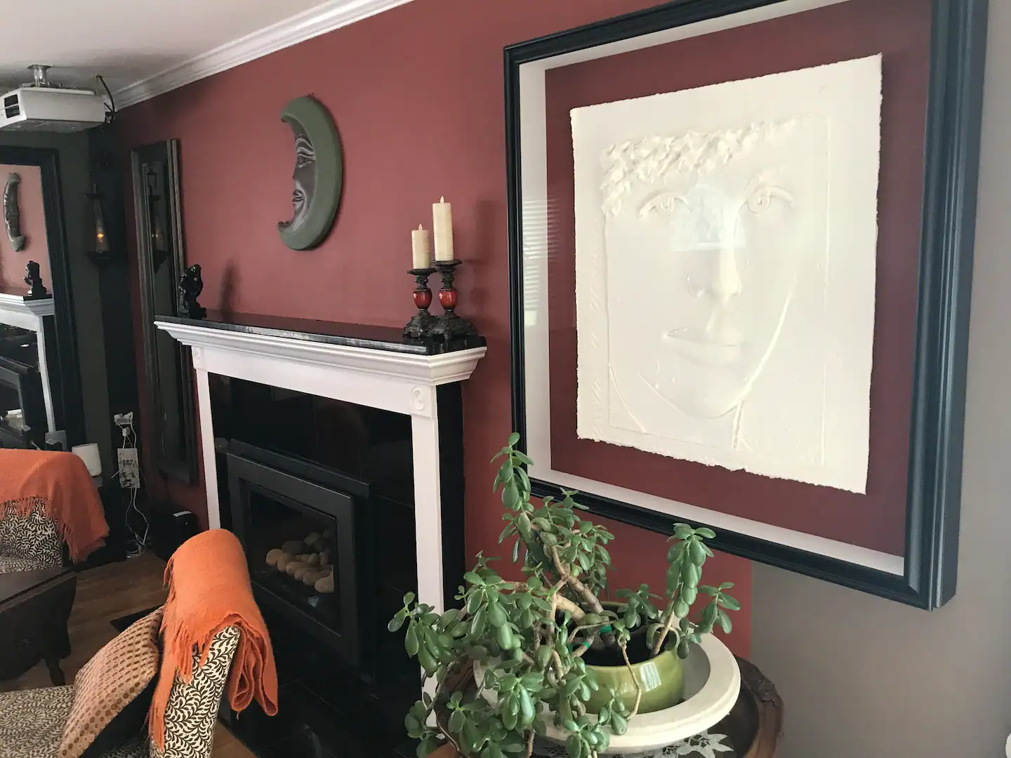 Notice artwork, fireplace, projector. View from dining room